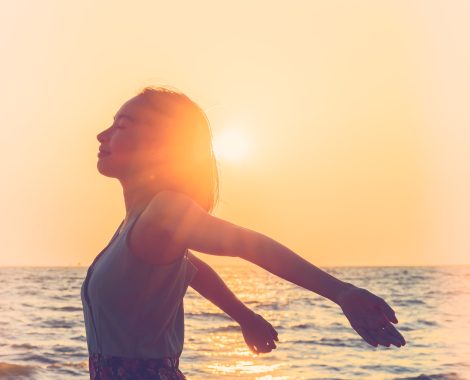 Happiness Young woman on the beach at sunset times - vintage effect and light leak filter processing style pictures